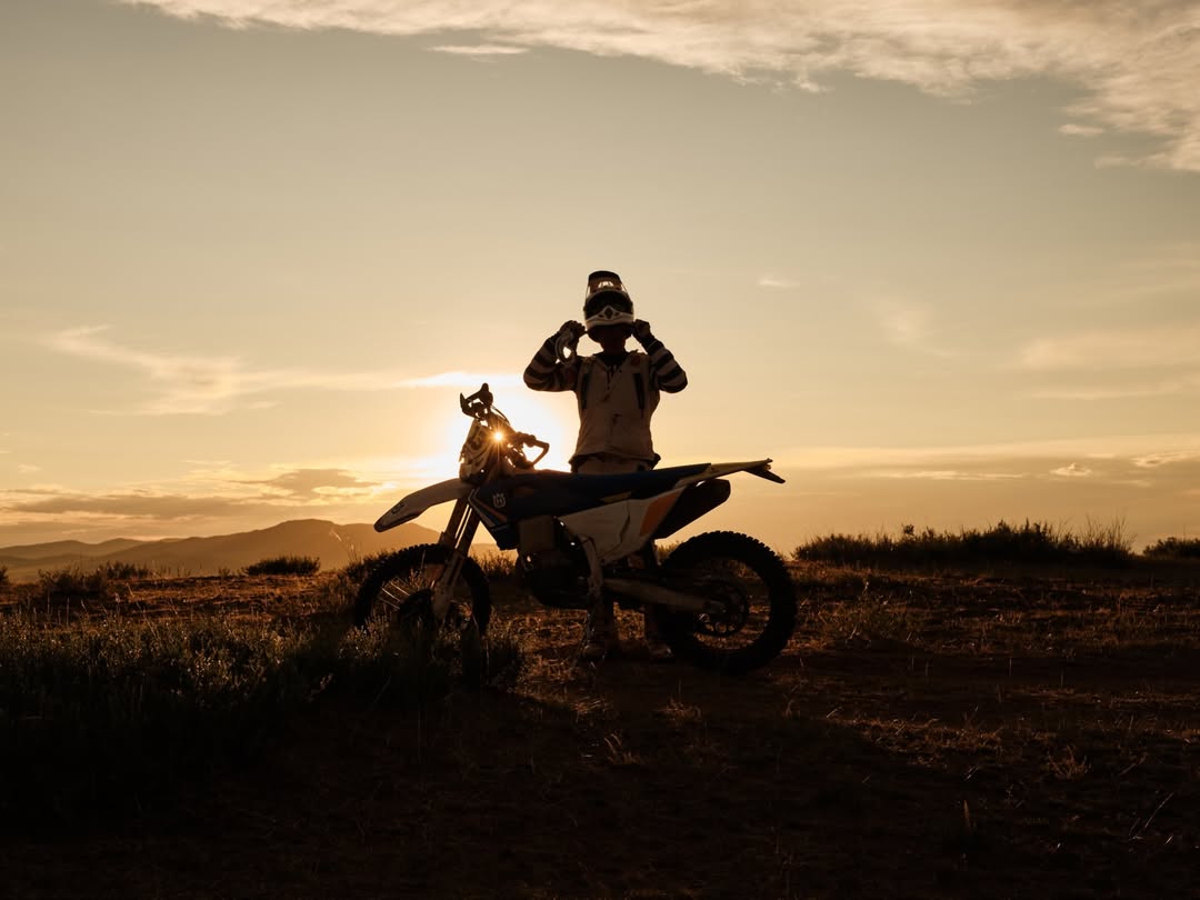 Rider at sunset on a Husqvarna in the Mongolian steppe